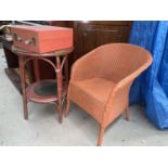 A brown Lloyd loom armchair and 2 tier occasional table