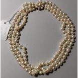 A cultured pearl triple strand choker, the 9 carat hallmarked gold clasp set with seed pears; a pair