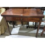 An early 19th century mahogany tea table with rectangular fold-over top, on square tapering legs