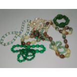 Two mother-of-pearl graduating bead necklaces; a mother-of-pearl leaf necklace; a small simulated