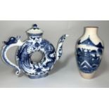 A Chinese teapot, circular donut shaped decorated in blue & white with dragons, character