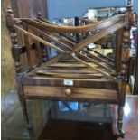 A 19th century style mahogany Canterbury with cross framed divisions, lower drawer, on turned legs