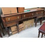 A 19th century crossbanded 4 drawers sideboard on turned legs