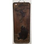 A 19th century Japanese carved wood rectangular panel depicting monkeys looking up at persimmon