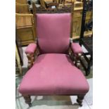 An Edwardian carved walnut armchair on turned legs, burgundy upholstery