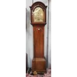 An 18th/19th century mahogany longcase clock with arch top hood and full length door, arched brass