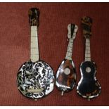 Three miniature musical instruments in tortoiseshell and mother-of-pearl: guitar, mandolin & banjo