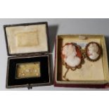 A small leather box containing diamond chips; etc.; 2 shell cameo brooches