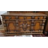 A period style carved oak sideboard of 3 cupboards and 3 drawers by Titchmarsh & Goodwin