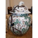A late 19th / early 20th century large Chinese ovoid crackle glaze covered vase decorated in