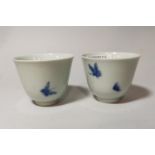 A pair of blue and white tea bowls decorated with butterflies, 6 character signature to base, height