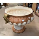 An ornamental terracotta urn on pedestal, painted antico rosso marble effect, 111cm height