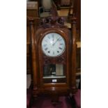 An 8 day American wall clock with inlaid decoration and carved finial