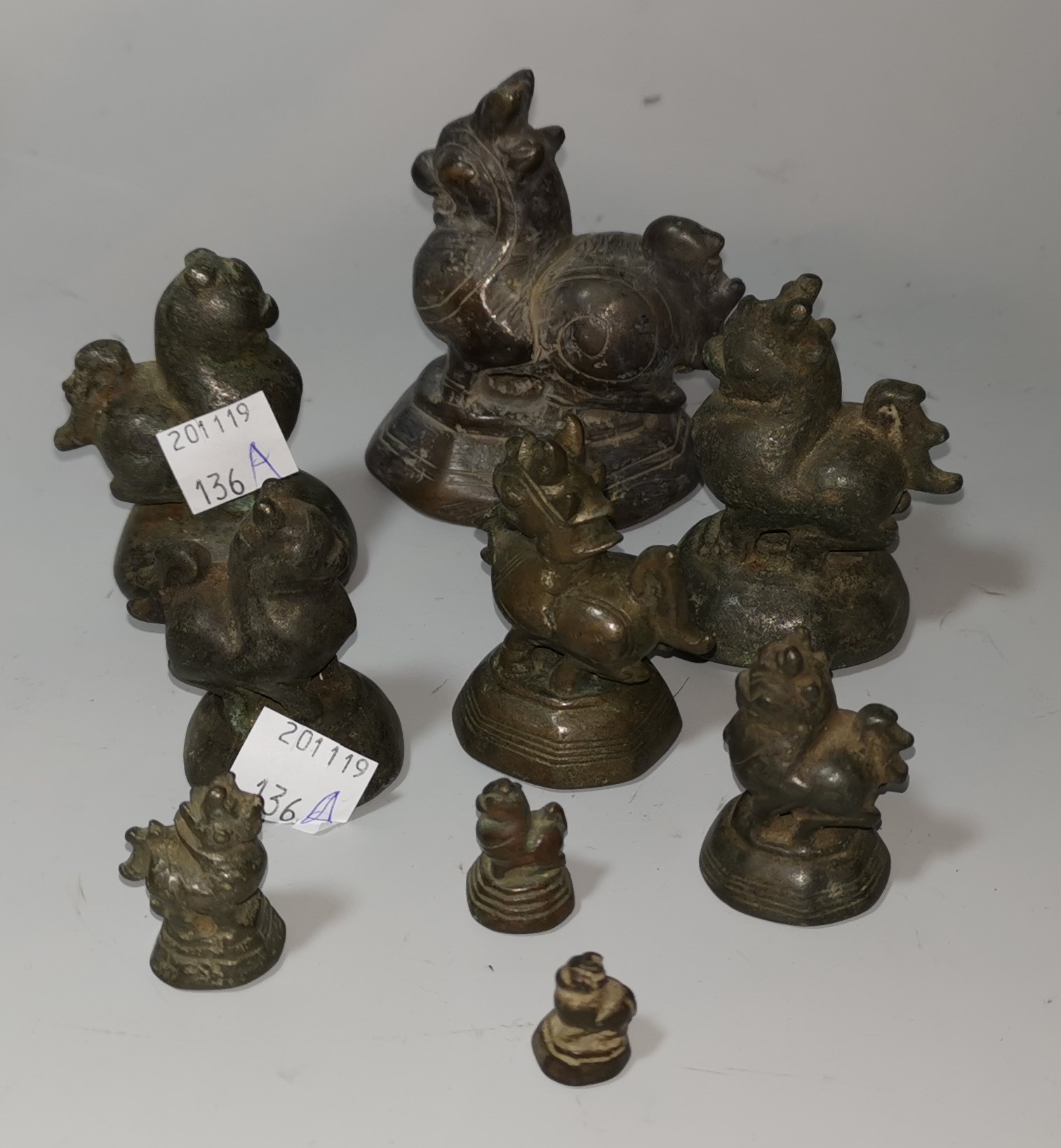 A Burmese set of 9 graduating bronze opium weights in the form of mythical birds, largest 8 cm