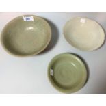 A Chinese celadon glazed stoneware bowl, internal relief decoration with trailing leaves, on