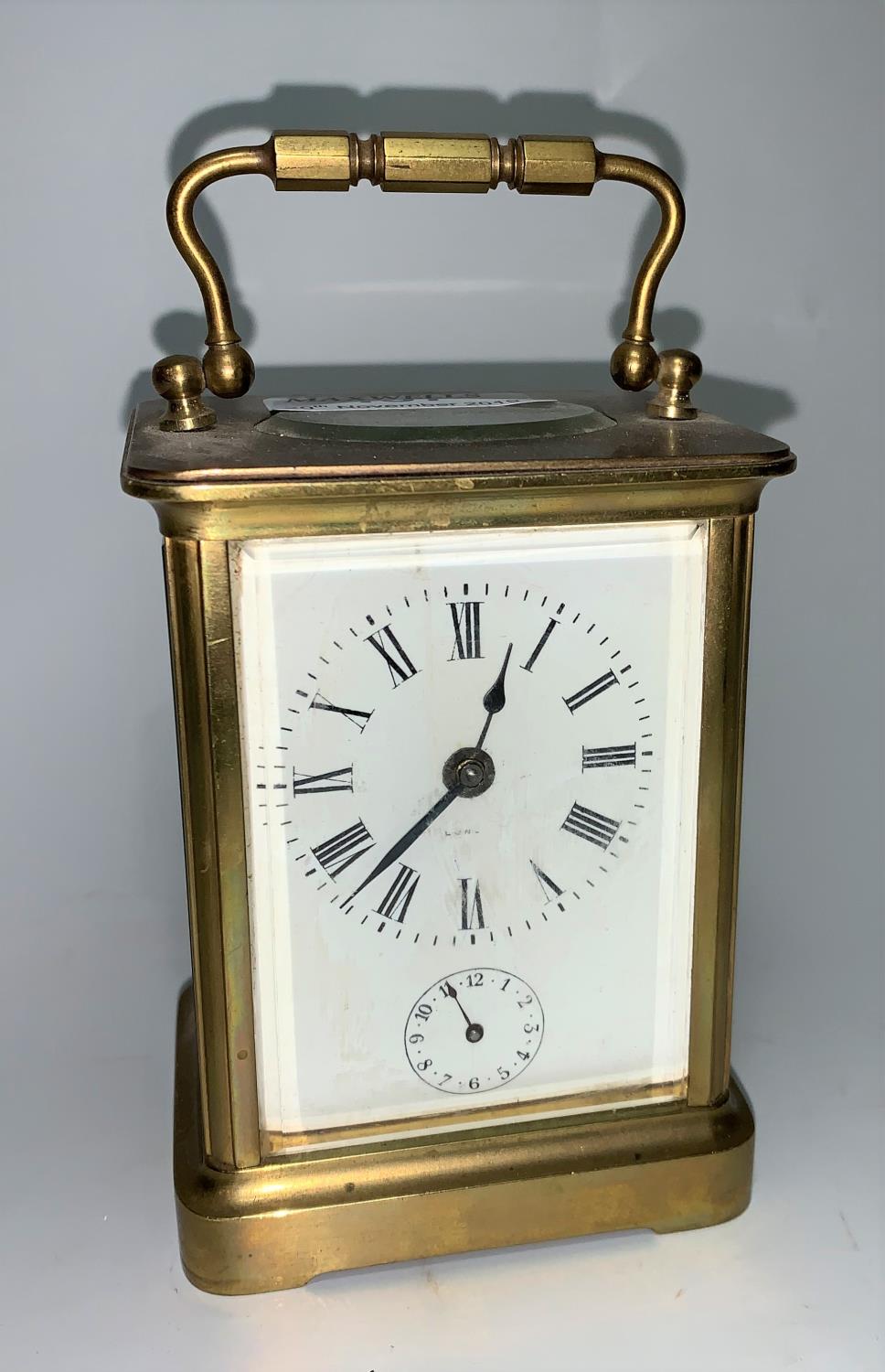 A brass carriage clock with timepiece movement and alarm