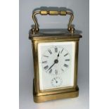 A brass carriage clock with timepiece movement and alarm