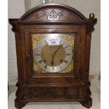 An Edwardian mantel clock in walnut arch top case, brass dial and striking on 2 gongs