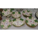 A Minton 18 piece dessert service decorated with reserve panels of exotic birds and flowers