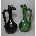 Two Canakkale ewers, one green glazed, one black (slight chip to lip of green ewer)