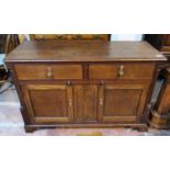 An 18th century oak small dresser base with 2 drawers, double cupboard and quarter turned reeded