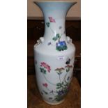 A large mid 19th century Chinese famille rose rouleau shape vase decorated with exotic flowers and