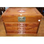 An oriental hardwood miniature cabinet of 4 drawers fitted for cutlery