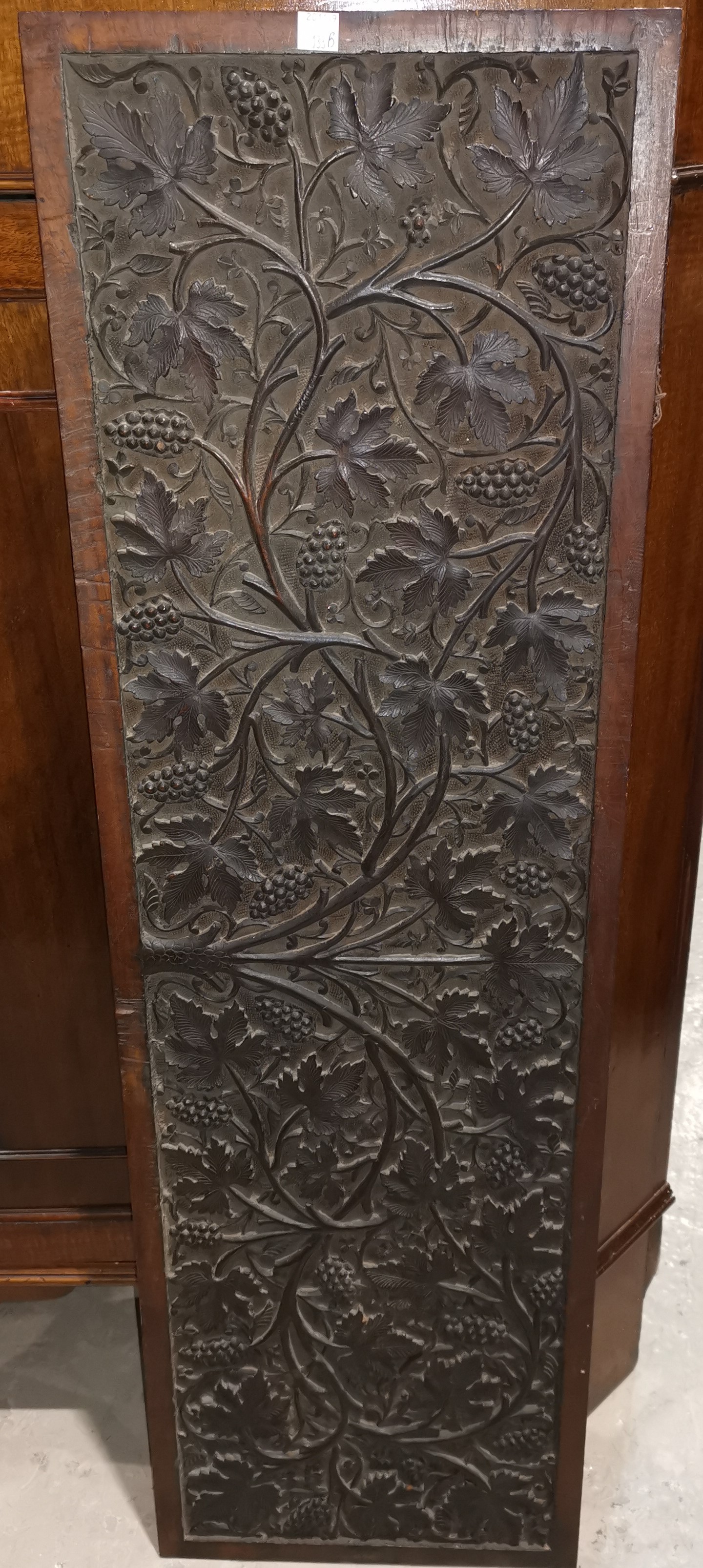 A late 19th/early 20th century Indian hardwood panel with all over carved decoration of fruiting