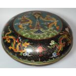 A large circular Chinese cloisonnee box, covered bowl decorated with dragons etc against a black and