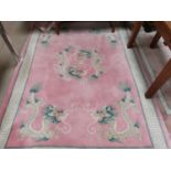 A Chinese rug with dragon pattern on pink ground, 110"x73"