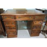 A late 19th/early 20th century mahogany kneehole desk with inset leather top, 3 frieze and 6