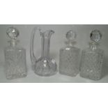 A cut claret jug; 3 crystal whisky decanters