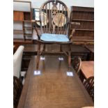 A Jacobean style dining suite comprising draw leaf table, 4 chairs and sideboard