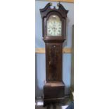 An early 19th century oak longcase clock with painted dial, arch top hood and 8 day weight driven