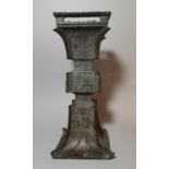 A Chinese bronze 'Gu' form vase, late Ming, shallow moulded key decoration with stylized
