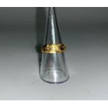An 18 carat gold wedding ring, engraved decoration, 3.8 gm