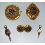 A Victorian suite of jewellery comprising circular brooch and pair of earrings; another brooch
