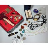 A jewellery box with costume jewellery and watches