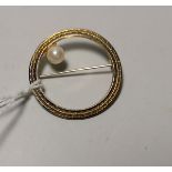 A yellow metal filigree circular brooch set single pearl, tamped '12K', 2.2 gm