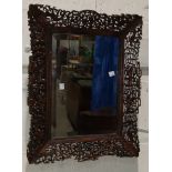 A bevelled edge rectangular wall mirror in Chinese hardwood carved and pierced frame, overall length