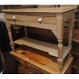 A stripped pine desk and two drawers