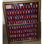 A collection of Japanese coloured figures "The 100 Emperors", in glazed wall display case