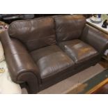 A modern fawn leather 2 seater settee and pouffee