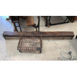 A cast iron dog grate; an oak rustic overmantel