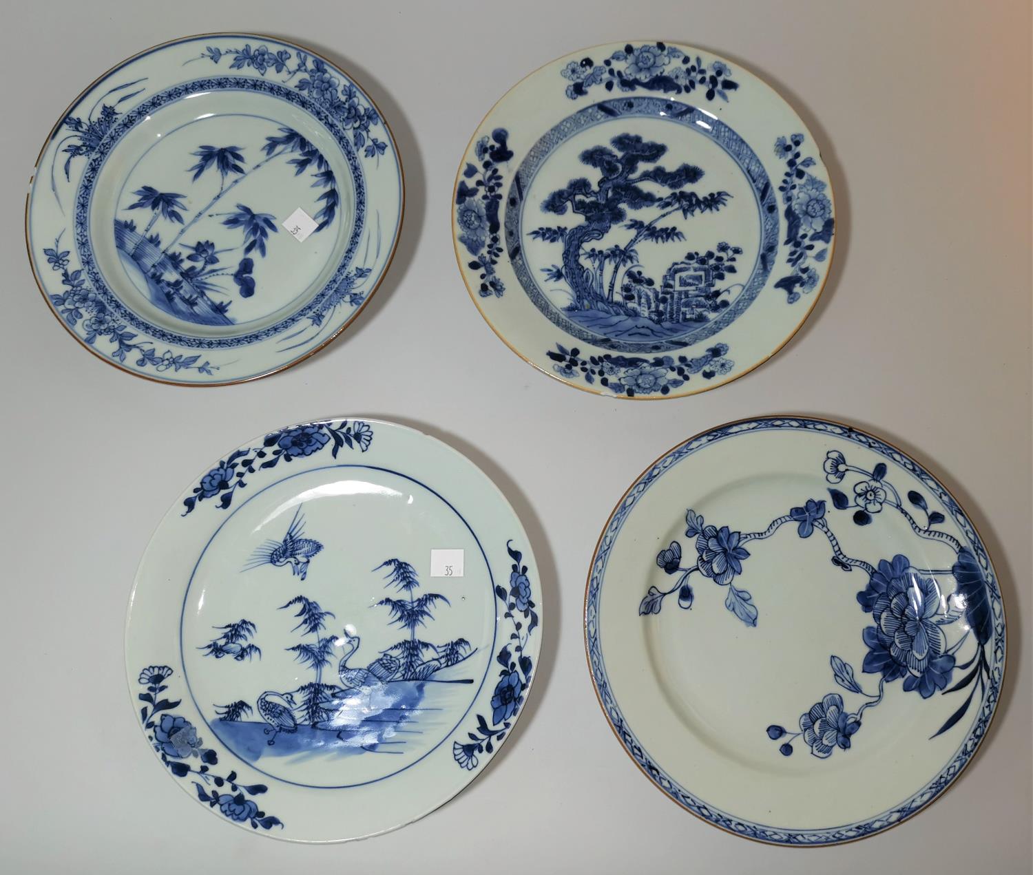 Chinese Chien Lung porcelain: a group of 4 plates decorated in underglaze blue, 22-23 cm (some rim