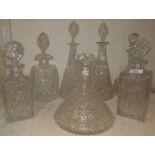 A pair of cut glass conical decanters; 2 square cut decanters; a ships' decanter; 2 others