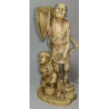A late 19th century Japanese okimono figure group: man with sickle and sheaf and boy with stick,