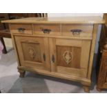 An edwardian stripped pine kitchen side cabinet with frieze drawers and double cupboard