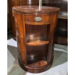 A Georgian style mahogany revolving bookcase with circular top, with books, by Wade