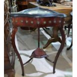 A triangular display table with lower shelf